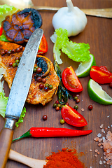 Image showing wood fired hoven cooked chicken breast on wood board