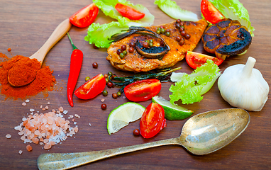 Image showing wood fired hoven cooked chicken breast on wood board