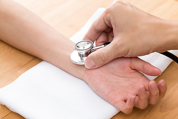 Image showing Chinese Doctor checking patients pulse rate 