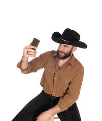 Image showing Man with cowboy hat talking a selfie