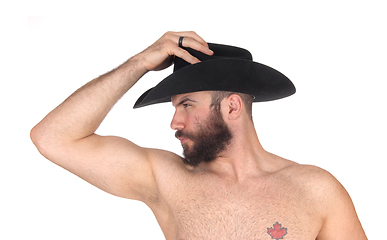 Image showing Close up of a shirtless man with a cowboy hat looking away