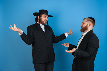 Image showing Portrait of a young orthodox jewish men isolated on blue studio background, meeting the Passover