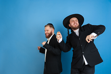 Image showing Portrait of a young orthodox jewish men isolated on blue studio background, meeting the Passover