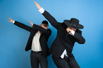 Image showing Portrait of a young orthodox jewish men isolated on blue studio background, meeting the Passover, dab