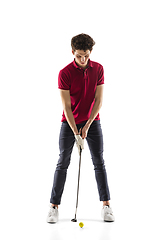 Image showing Golf player in a red shirt training, practicing isolated on white studio background