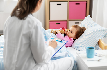 Image showing doctor with clipboard and sick girl in bed at home