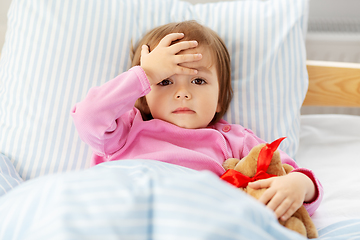 Image showing sick little girl lying in bed at home