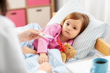 Image showing doctor measuring sick girl's temperature at home