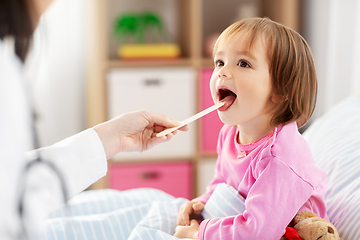 Image showing doctor checking sick girl's throat at home