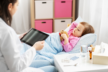 Image showing doctor with tablet computer and sick girl in bed