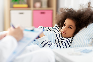 Image showing doctor with clipboard and sick girl in bed at home