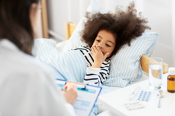 Image showing doctor with clipboard and sick girl in bed at home