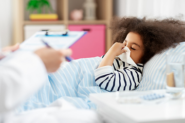 Image showing doctor and sick girl in bed blowing nose