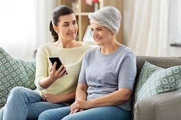 Image showing daughter and senior mother with smartphone at home