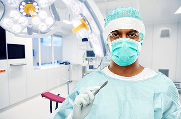 Image showing indian surgeon with scalpel over operating room
