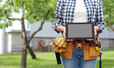 Image showing woman builder with working tools showing tablet pc