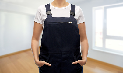 Image showing close up of female painter or builder in overall