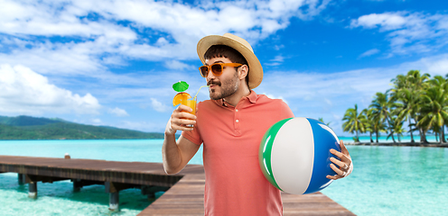 Image showing happy man in straw hat with juice on beach