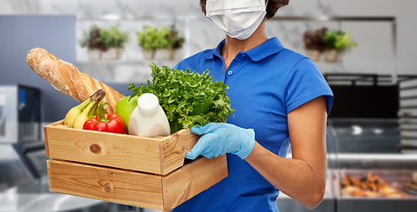 Image showing delivery woman in face mask with food in box