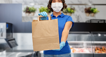 Image showing delivery woman in face mask with paper bag