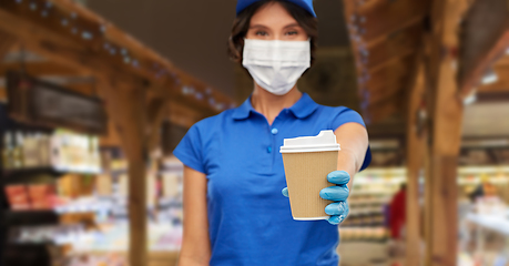 Image showing saleswoman in face mask with takeaway coffee cup