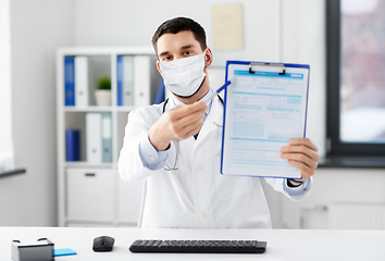 Image showing doctor with clipboard having video call at clinic