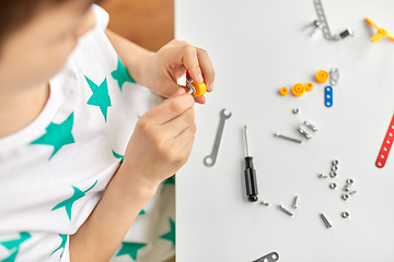 Image showing little boy playing with airplane toy at home