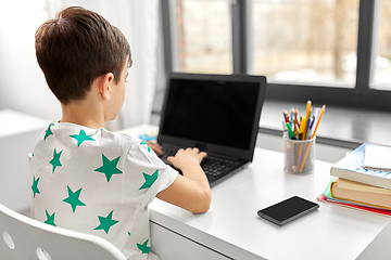 Image showing student boy typing on laptop computer at home