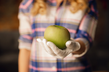 Image showing Close up of female hand holding green apple, healthy food, fruits