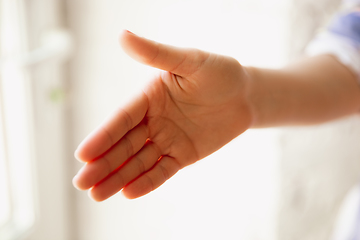 Image showing Close up view of caucasian female hand greeting somebody, copyspace