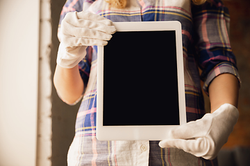 Image showing Coronavirus. Novel coronavirus 2019-nCoV , COVID-29, hands of a woman in gloves holdes tablet