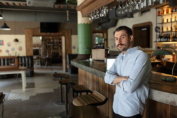 Image showing Public institutions closed due to COVID-19 or Coronavirus outbreak lockdown, stressed owner of small business alone in his cafe, restaurant, bar