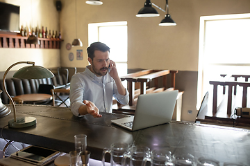 Image showing Restaurant, cafe, bar closed due to COVID-19 or Coronavirus outbreak lockdown, stressed owner of small business trying to find solution