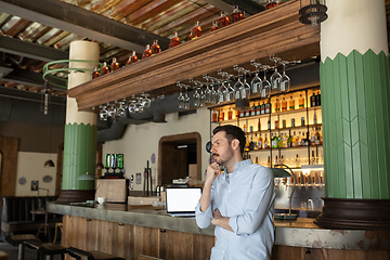 Image showing Public institutions closed due to COVID-19 or Coronavirus outbreak lockdown, stressed owner of small business alone in his cafe, restaurant, bar