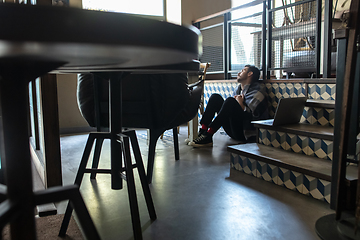 Image showing Public institutions closed due to COVID-19 or Coronavirus outbreak lockdown, stressed owner of small business alone in his cafe, restaurant, bar