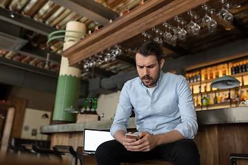 Image showing Public institutions closed due to COVID-19 or Coronavirus outbreak lockdown, stressed owner of small business alone in his cafe, restaurant, bar