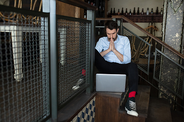 Image showing Public institutions closed due to COVID-19 or Coronavirus outbreak lockdown, stressed owner of small business alone in his cafe, restaurant, bar