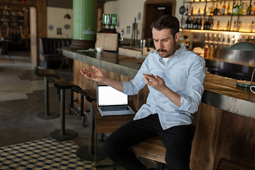 Image showing Public institutions closed due to COVID-19 or Coronavirus outbreak lockdown, stressed owner of small business alone in his cafe, restaurant, bar