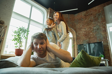 Image showing Family spending nice time together at home, looks happy and cheerful, fighting with pillows