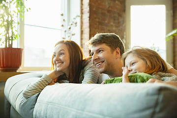 Image showing Family spending nice time together at home, looks happy and cheerful, lying down together