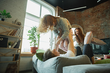 Image showing Family spending nice time together at home, looks happy and cheerful, fighting with pillows