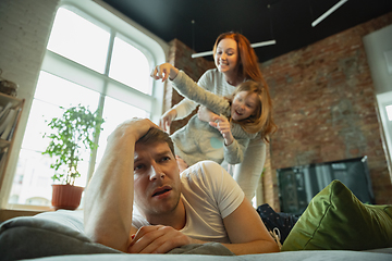 Image showing Family spending nice time together at home, looks happy and cheerful, fighting with pillows