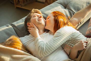 Image showing Family spending nice time together at home, looks happy and cheerful, lying down together