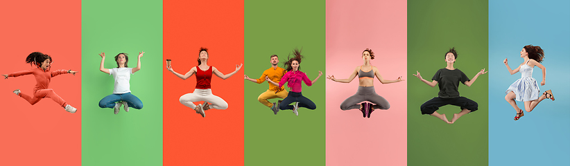 Image showing Young emotional people jumping high, look happy and cheerful on multicolored background