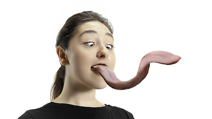 Image showing Smiling girl opening her mouth and showing the long big giant tongue isolated on white background, crazy and attracted