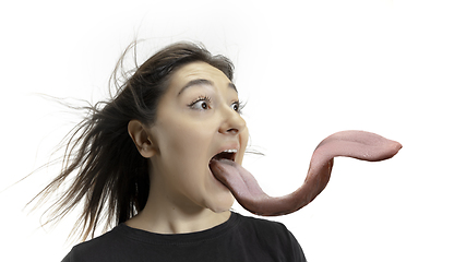 Image showing Smiling girl opening her mouth and showing the long big giant tongue isolated on white background, crazy and attracted