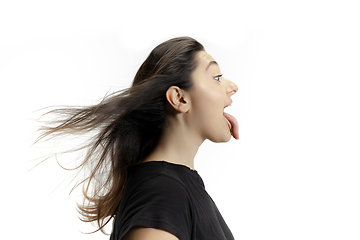 Image showing Smiling girl opening her mouth and showing the long big giant tongue isolated on white background, crazy and attracted