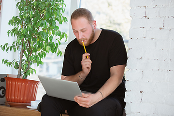 Image showing Young man studying at home during online courses for engineers, doctors, ecologists