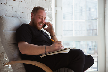 Image showing Young man studying at home during online courses for managers, marketers, buyers