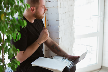 Image showing Young man studying at home during online courses for engineers, doctors, ecologists